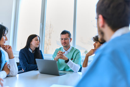 A dedicated group of doctors and medical nurses attentively listens to their colleagues work plan in...
