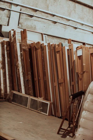 A vast warehouse in the forestry industry, showcasing a plethora of wooden products, including boards and various timber items neatly organized in storageの写真素材