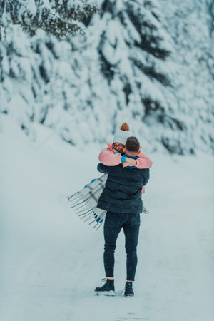 On a snowy Valentines Day, this romantic couple shares warmth, laughter, and tender embraces, creating a blissful winter love story.の写真素材