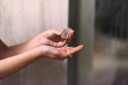 Close up shot, a woman applies hydrating cream to her hand, indulging in a daily skincare ritual that promotes softness, health, and well beingの写真素材