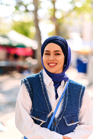 Radiant Beauty: A Woman in Hijab Embracing the Sunshine.の写真素材