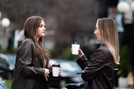 Women Laughing with Coffee Outdoors