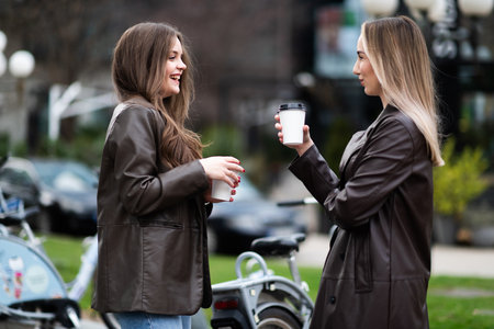 Women Laughing with Coffee Outdoors
