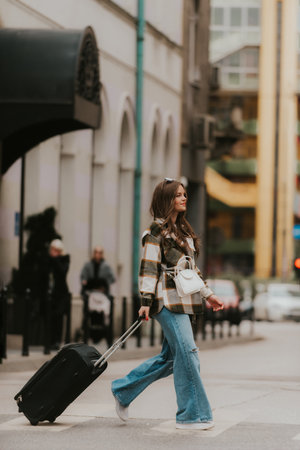 Stylish Woman Walking with Suitcase in Urban Street.