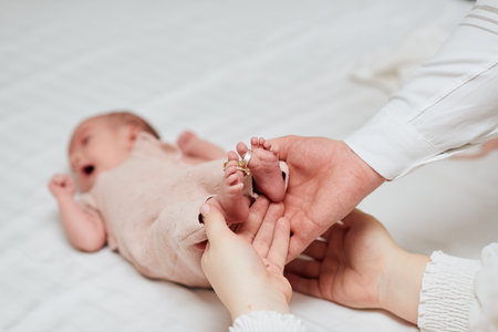 Newborn Baby Feet with Wedding Rings on Toesの写真素材