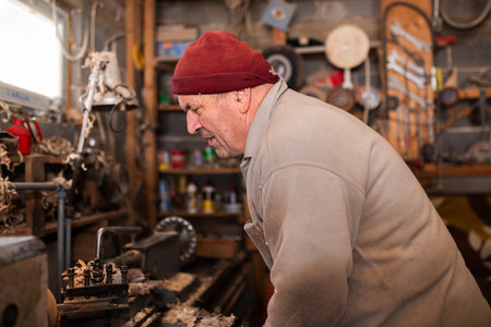 Elderly Craftsman Working in a Rustic Workshop