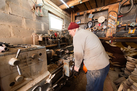 Elderly Craftsman Working in a Rustic Workshop