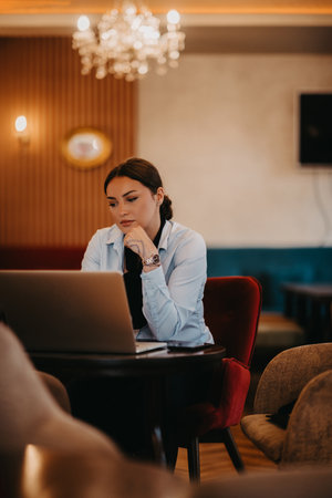 Radiant Latina businesswoman confidently leads business meeting over coffee.の写真素材