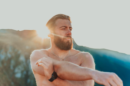 A man stretching his arms after a hard workout in the early hours of the morning