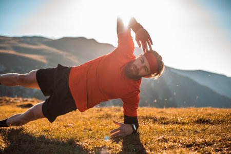 A man doing abs exercises on top of a mountain