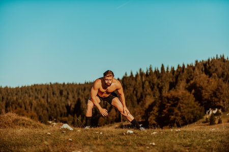 A man stretching after a hard workout in the early hours of the morningの写真素材