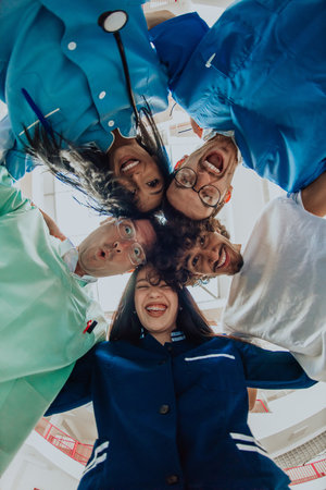 Group of doctors a medical nurse, and a surgeon are captured in a heartfelt embrace, showcasing their unity, teamwork, and profound connection in the healthcare field.の写真素材
