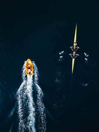 Rowing Team and Motorboat Aerial Viewの写真素材