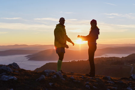 Couple enjoys a sunset hike in the mountains, sharing a moment of connection and natures beauty