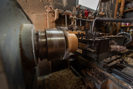 Woodworking Lathe Shaping Wood With Metal Tools In Workshop Carpentry Equipment For Wood Turning And Woodworking.の写真素材