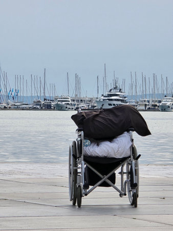 Empty Wheelchair at the Harbor with Luxury Yachts and Boats in the Background