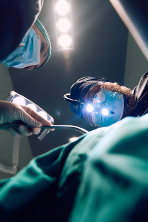 Surgeons Performing Complex Surgery Under Bright Operating Room Lights With Loupes and Masks
