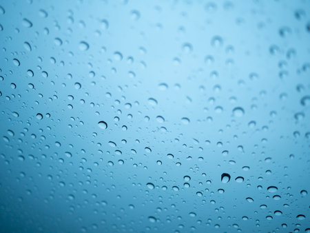 Water drops on the glass. Blue background. Shallow DOF