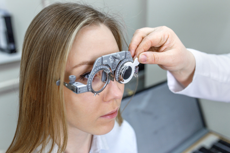 Ophthalmology - ophthalmologist checks the eyes of a girlの写真素材