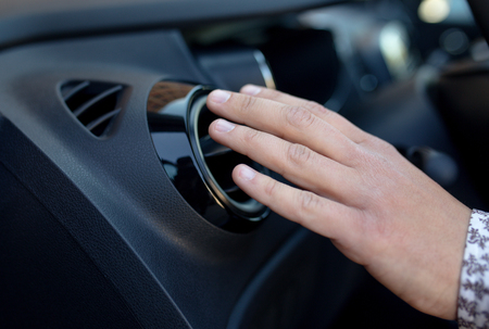 Driver hand on air ventilation grille with power regulator, checking the air from air ventilation in the carの写真素材