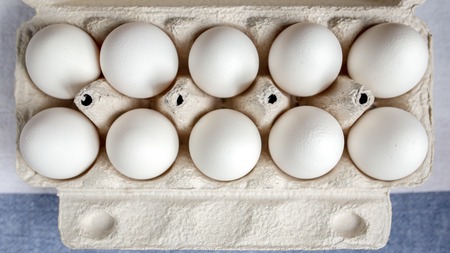 Packing eggs in a cardboard box top and close-up viewの写真素材