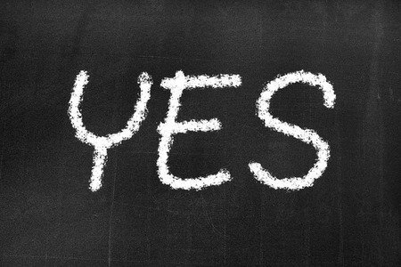 Blackboard with the text 'yes' background textureの写真素材
