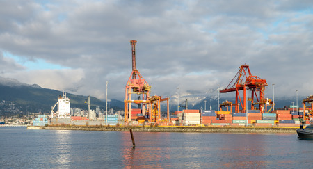 Construction and Container Cargo ship in the Harbor Vancouver, British Columbia. Picture took on Jan 2017 during clear sky.のeditorial素材