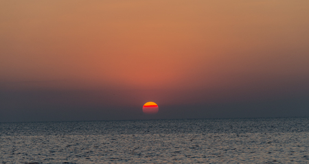 Seagull was flying above the sea shore during sunset Dec 2017.の写真素材