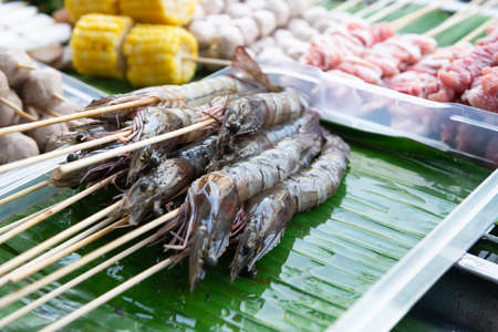 Raw pork sausage vegetable shrimp placed on dish prepare for grill.の写真素材