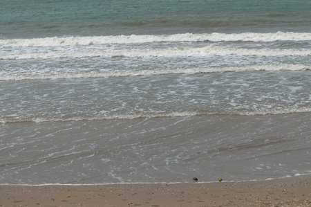 beach and sea in summer, close-up of sand and wavesの写真素材