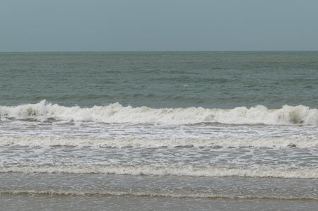Waves in the sea on a sunny day. Sea waves on the beach.の写真素材