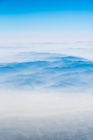 10,000 meters high altitude aerial view of the mountains and the sea of cloudsの写真素材