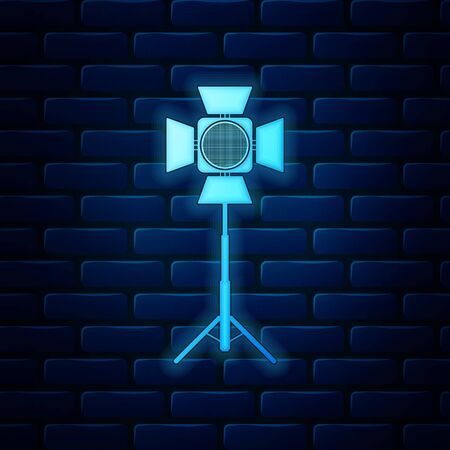 Glowing neon Movie spotlight icon isolated on brick wall background. Light Effect. Scene, Studio, Show. Vector Illustrationのイラスト素材