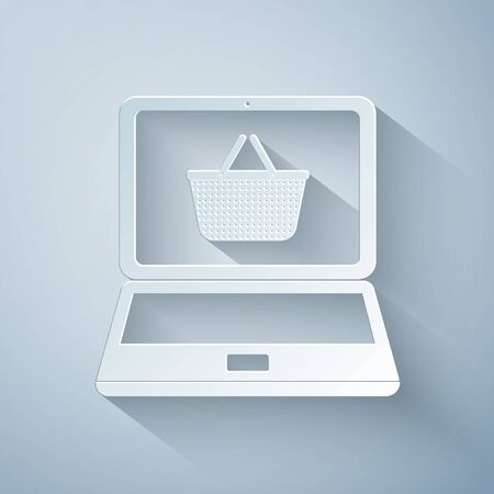 Paper cut Shopping basket on screen laptop icon isolated on grey background. Concept e-commerce, e-business, online business marketing. Paper art style. Vector Illustrationのイラスト素材