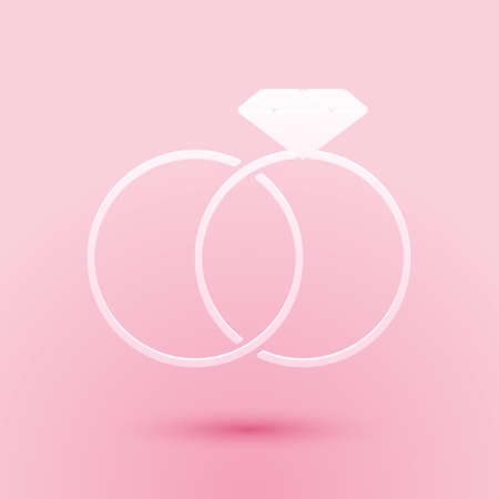 Paper cut Wedding rings icon isolated on pink background. Bride and groom jewelery sign. Marriage icon. Diamond ring icon. Paper art style. Vectorのイラスト素材