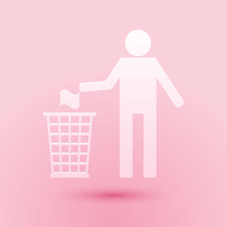 Paper cut Man throwing trash into dust bin icon isolated on pink background. Recycle symbol. Paper art style. Vectorのイラスト素材