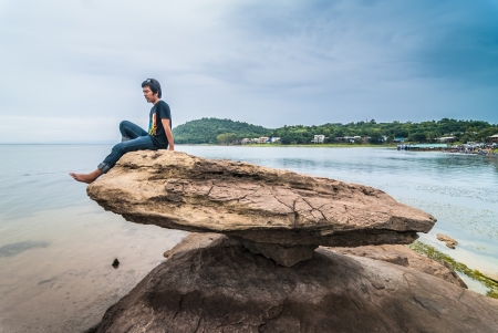 Man standing on rock mass The lighting conditions change  It has power の写真素材