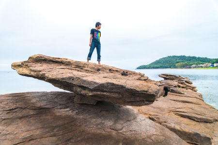 Man standing on rock mass The lighting conditions change  It has power の写真素材