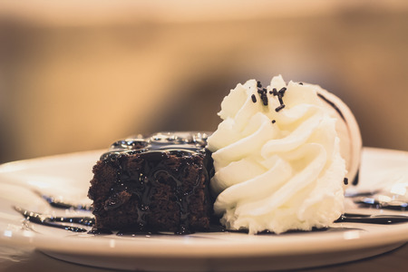 French toast topped with sliced bananas, ice cream cheese sauce and caramel syrup. Extreme  depth of field with selective focus on french toast and some blur on corner of plate.の写真素材