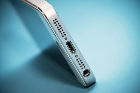 Bangkok, Thailand- October 4, 2015: The gold Apple iPhone 5s on blue paper background and iPhone 5s designed and developed by Apple Inc., it was released on September 20, 2013のeditorial素材