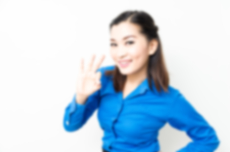 Blur effect of image of a young woman with a lovely look and charming smile in blue shirtの写真素材