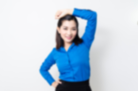 Blur effect of image of a young woman with a lovely look and charming smile in blue shirt