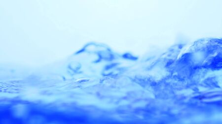 Soft blur focus of Abstract water splash surface filling the frame with the water drop and waving liquid with an air bubble on a white background and copy spaceの写真素材