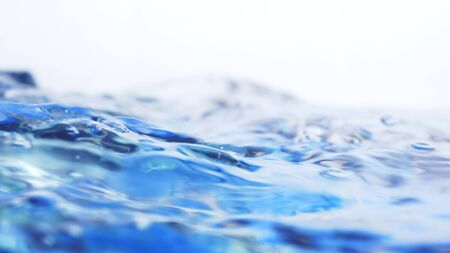 Soft blur focus of Abstract water splash surface filling the frame with the water drop and waving liquid with an air bubble on a white background and copy spaceの写真素材