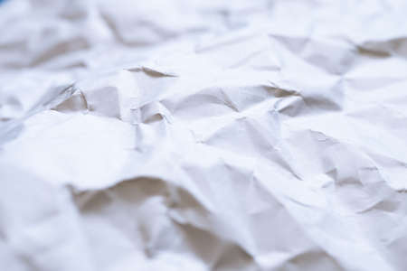 The white paper is wrinkled with a shadow and selective focus texture background.の写真素材