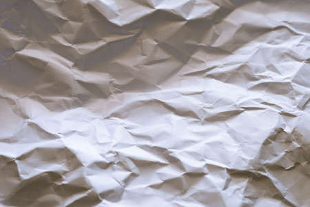 The white paper is wrinkled with a shadow and selective focus texture background.の写真素材