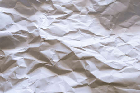 The white paper is wrinkled with a shadow and selective focus texture background.の写真素材