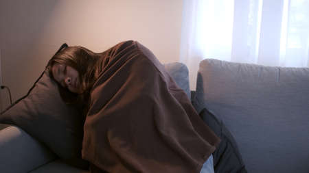 Young Asian woman with a black edge shakes her whole body is about to catch a cold and uses a...