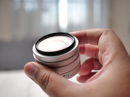 Capturing the moment photography gear in hand home studio product detail indoor setting close-up photography essentialsの写真素材