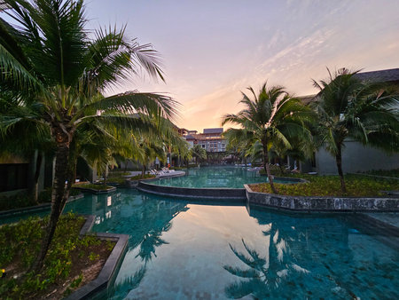 Serene poolside retreat luxury resort scenic view tropical environment tranquil atmosphereの写真素材